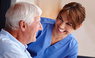 Nurse smiling at patient