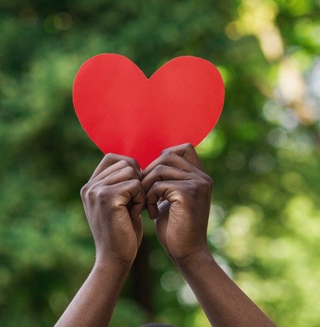 Hand holding paper heart
