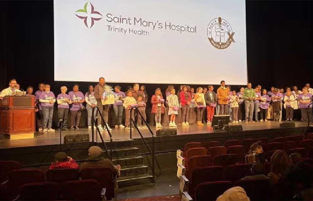Young students on a stage in front of an audience