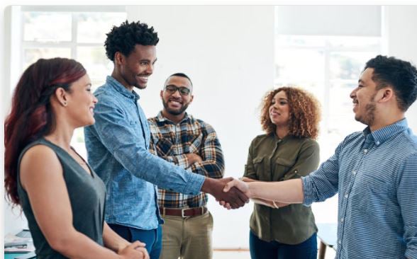 group of colleagues shaking hands
