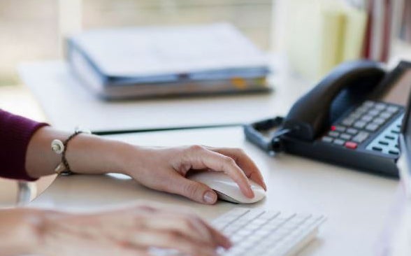 Hand on computer mouse